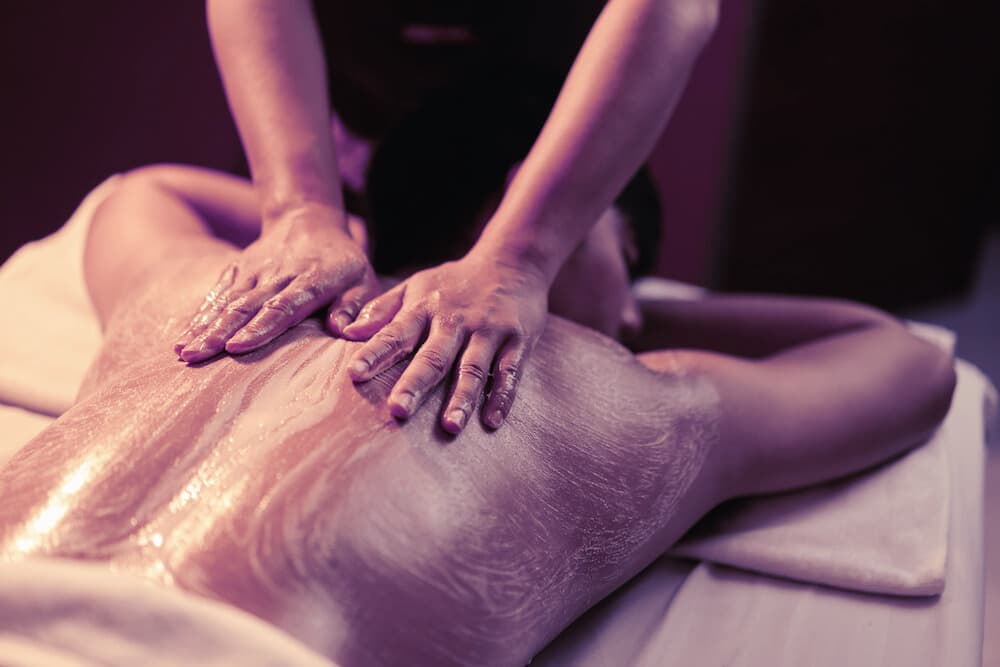 Body scrub treatment with exfoliating mitt and warm towels