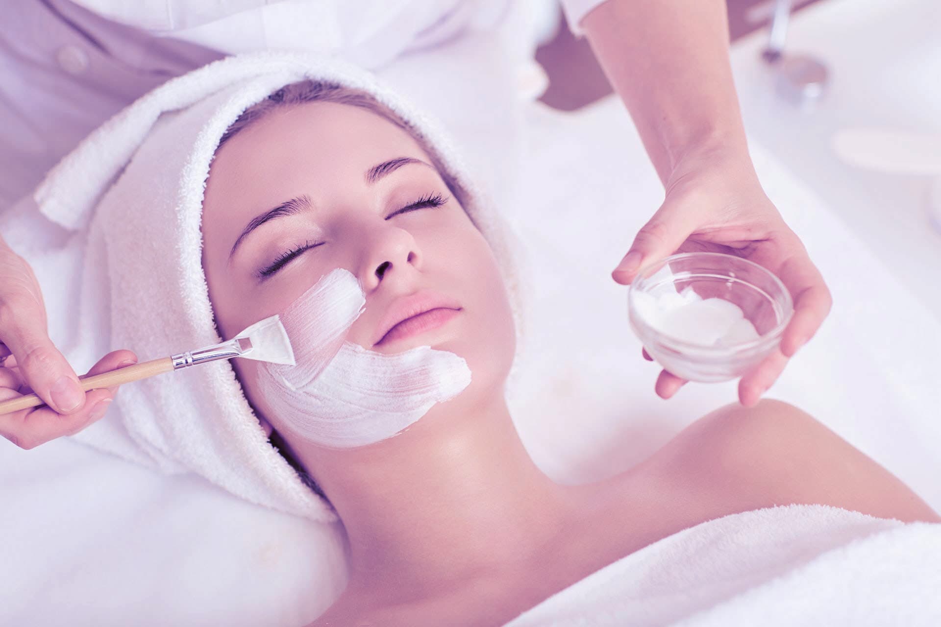 Spa facial treatment with mask and warm towel wrap